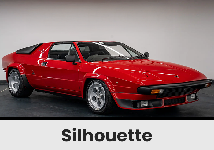 Red Vintage Twoseater Sports Car in a Studio Facing Right with Black Bumper and Silver Wheels