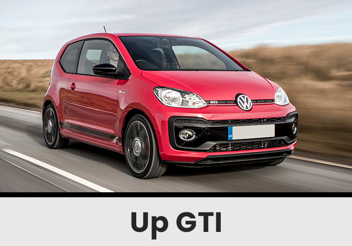 Front Threequarter View of a Red Volkswagen Up Gti Driving on a Rural Road with Motion Blur in the Background